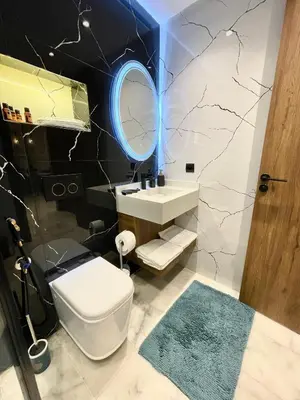 a bathroom with a white toilet and a mirror at Q11 Studio au Cœur de Casablanca Proximité et Confort in Casablanca