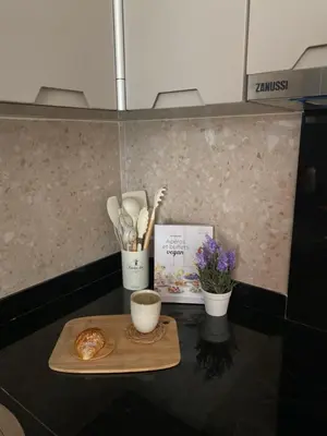 a counter with a cutting board with a cup of coffee and flowers at Zafiro - L'appartement de vos rêves - Casablanca in Casablanca