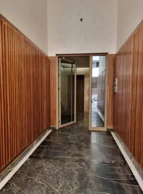 an empty hallway with wooden walls and a glass door at Zafiro - L'appartement de vos rêves - Casablanca in Casablanca