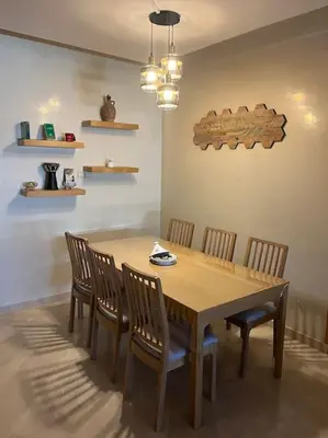 a dining room table with four chairs around it at Family Appartement Nouaceur Aéroport Med V in Nouaceur