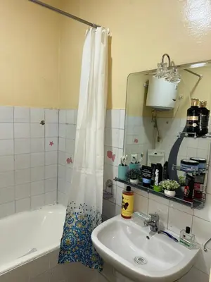 a bathroom with a sink and a tub and a mirror at Chambre cosy au cœur de Rabat in Rabat