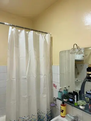 a bathroom with a shower curtain and a sink at Chambre cosy au cœur de Rabat in Rabat