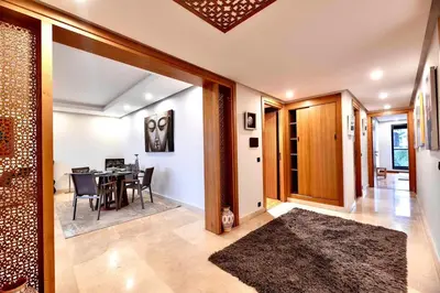 a dining room with a table and a dining roomiasm at Appartment De Lux a California in Bali Luxury Residence in Casablanca