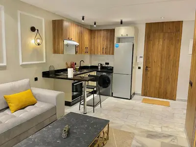 a living room with a couch and a kitchen at C39 1BR Studio - Cozy & Central in Maarif in Casablanca