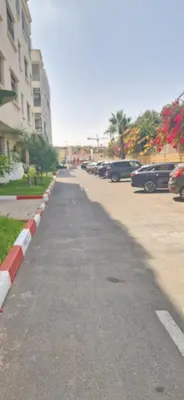 a street with cars parked in a parking lot at Cozy Guesthouse, Ain Sebaa, Casablanca in Casablanca