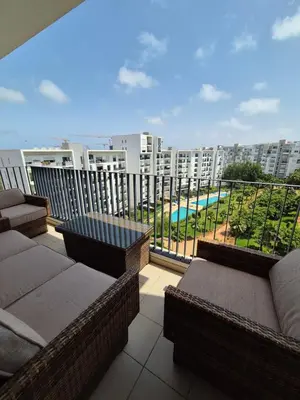 a balcony with couches and a view of a pool at My Cosy Place - Apartment 2BR - Piscine -Résidence Marbella Hay Riad in Rabat