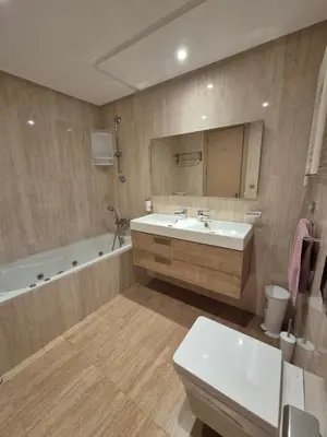a bathroom with a sink and a tub and a toilet at My Cosy Place - Apartment 2BR - Piscine -Résidence Marbella Hay Riad in Rabat