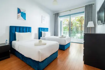 a hotel room with two beds and a window at Résidence Luxe avec Plage Privée in Bouznika