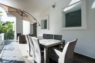a dining room with a table and chairs at Résidence Luxe avec Plage Privée in Bouznika