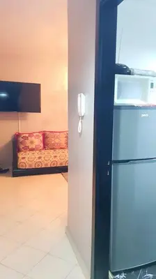 a living room with a refrigerator and a couch at Appartement entier Familial Tamaris-Dar Bouazza-Casablanca in Dar Bouazza