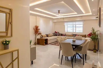 a living room with a table and a couch at Joli appartement 2 chambres in Casablanca