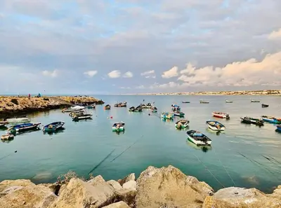 a group of boats in a body of water at Confort Moderne à 2 Pas de la Mer Calme Absolu in Dar Bouazza