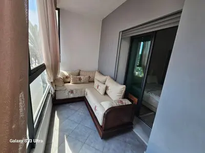 a living room with a couch and a window at Studio a Mohammedia pied dans l'eau in Mohammedia