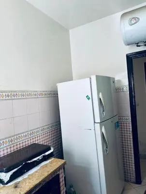 a kitchen with a white refrigerator in a room at chic chambre meublée in Casablanca