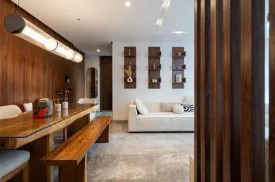 a living room with a white couch and a table at Élégance Urbaine Casa Finance city in LʼOasis