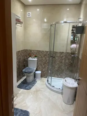 a bathroom with two toilets and a shower at Résidence kettani piscine bouznika in Bouznika