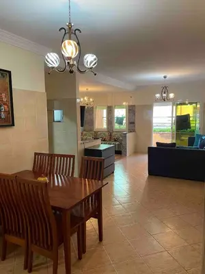 a dining room and living room with a table and chairs at Sahara beach Mansouria in Mansouria
