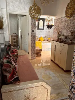 a room with a kitchen and a living room at Maison wafaa in O Ben Slimane