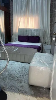 a bedroom with a bed with a white canopy at Maison wafaa in O Ben Slimane