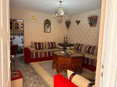 a living room with a couch and a table at Maison wafaa in O Ben Slimane