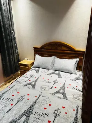 a bed with a blanket with the eiffel tower at Studio charme à prix doux in Casablanca