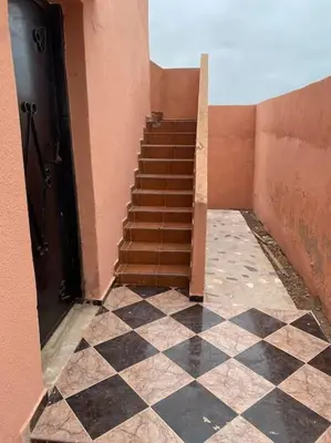 a staircase in a building with a checkered floor at Villa Casablanca-Sidi Rahal à 5 min de la plage in Sidi Rahal