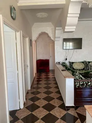 a hallway with a checkered floor in a house at Villa Casablanca-Sidi Rahal à 5 min de la plage in Sidi Rahal