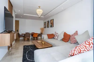 a living room with a couch and a table at Appartement Royal in Beni Brour
