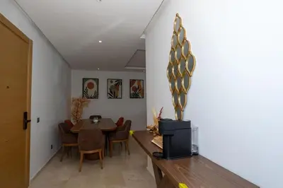 a dining room with a table and chairs at Appartement Royal in Beni Brour