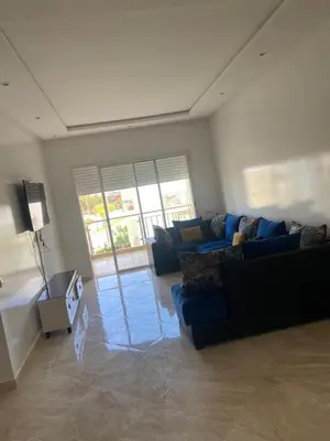 a living room with a couch and a table at Casabay sidirehal in Sidi Rahal