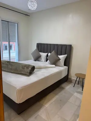 a large bed in a room with a window at Residence le 11 in Casablanca