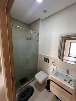 a bathroom with a shower and a toilet and a sink at Trendy Condo - Stunning Views in Aïn Harrouda
