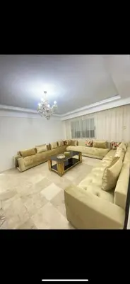 a large living room with couches and a chandelier at La résidence de Palais in Bouskoura