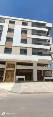 a tall white building with a lot of windows at La résidence de Palais in Bouskoura