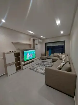 a living room with a couch and a flat screen tv at Magic housse in Pont Blondin
