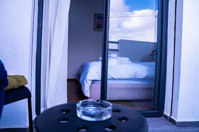 a mirror reflecting a bed in a bedroom with a table at R102- Stylish and Functional 1 BR Apartment at the center of Belvedere in Casablanca