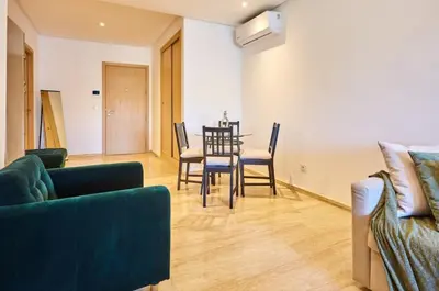 a living room with a couch and a table and chairs at Casablanca Maarif in Maarif