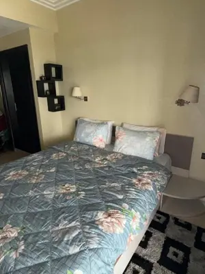 a bedroom with a bed with flowers on it at La perle de Tamaris in Casablanca