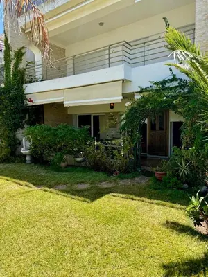 a large house with a yard with a lawn sidx sidx sidx at La perle de Tamaris in Casablanca