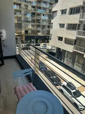 a balcony with a table and a view of a city at Appartement de prestige à Casablanca in Casablanca