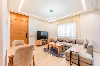 a living room with a couch and a tv at Casablanca Centre Confort Luxe Emplacement idéal in Maarif