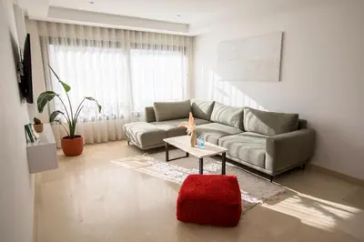 a living room with a couch and a table at Haut Standing 2-Bedroom Apartment in Gauthier in Casablanca