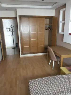 a room with a desk and a table and a door at Studio Charmant & Cosy à Agdal in Gare de Rabat-Aguedal