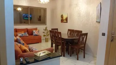 a living room with a table and chairs and a couch at Welcomeمرحبا in Casablanca