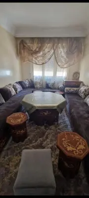 a living room with a couch and a table at Residence Louma in Mohammedia
