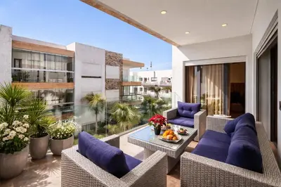 an outdoor patio with couches and a table at Luxury 2Ch Face Plage 3 Piscines Jardin in Tamaris