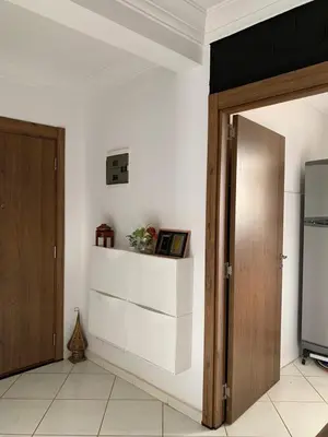 a room with a door and a shelf on the wall at Résidence MaRwa in Oulad Kerroum
