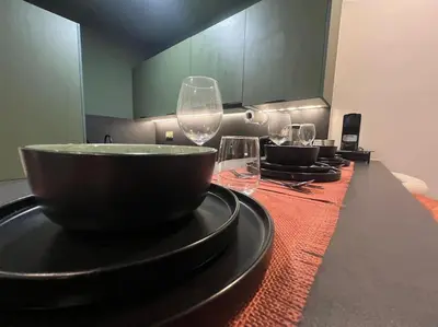 a table with wine glasses and a bowl on it at Luxury Residence So Stylish & Bright Appartement Hotel Au Coeur de Casablanca prés de Carrefour et 3 Min de La Gare Ferroviere Oasis in Casablanca
