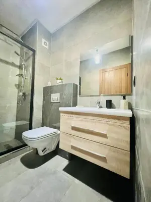 a bathroom with a toilet and a sink and a shower at Appartement Dahlia - Haut Standing - Mohammedia Natura Living in Mohammedia