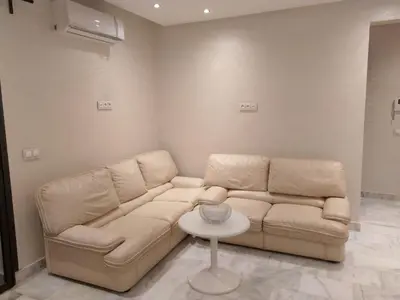 a living room with a couch and a table at Sweet Home in Maarif